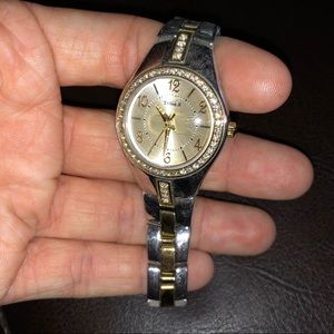 Silver and gold watch with rhinestones.